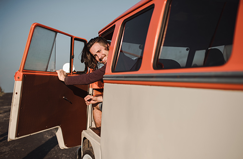 Woman opening a roof box on top of a white car